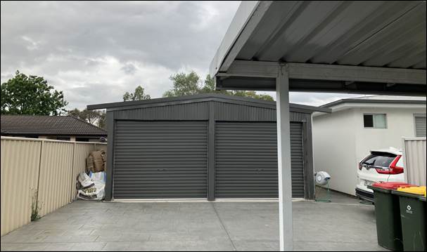 A garage with a roof

Description automatically generated