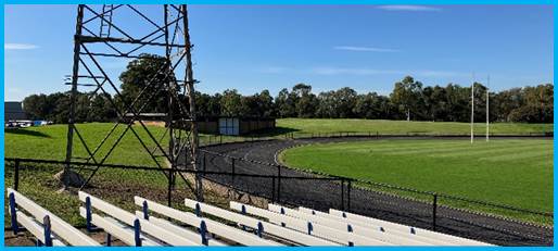 A stadium with a metal tower and white seats

Description automatically generated with medium confidence